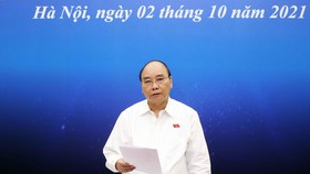 Chủ tịch nước Nguyễn Xuân Phúc: Sẽ có chính sách cụ thể hỗ trợ cho doanh nghiệp trong giai đoạn khó khăn hiện nay về tài chính, tiền tệ. Ảnh: TT