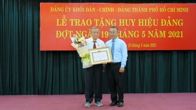 Đồng chí Võ Ngọc Quốc Thuận trao Huy hiệu 55 năm tuổi Đảng cho đảng viên Nguyễn Hoàng. Ảnh: THU HƯỜNG