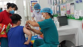 Nhân viên y tế tiêm vaccine Covid-19 cho trẻ
