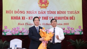 Ông Đoàn Anh Dũng (bên trái) nhận hoa chúc mừng từ Bí thư Tỉnh ủy Bình Thuận Dương Văn An.