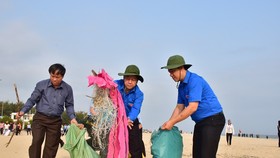 Ông Phan Ngọc Thọ, Chủ tịch UBND tỉnh Thừa Thiên - Huế (giữa) đang dọn rác trên bãi biển Thuận An.