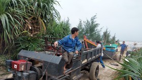 Sáng 25-10, ngư dân ở thị trấn Thiên Cẩm (huyện Cẩm Xuyên, Hà Tĩnh) kéo tàu lên bờ tránh bão