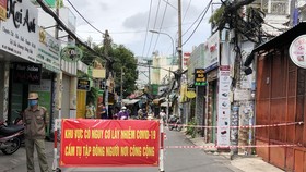 Tổ dân phố dựng rào chắn để hạn chế phương tiện ra vào trên đường Thống Nhất,  phường 10, quận Gò Vấp. Ảnh: BÙI ANH TUẤN