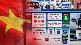 Vietnam has witnessed an explosion of digital wallets, such as MoMo, Grab's Moca, ZaloPay and VNPAY, used at businesses like this convenience store in Ho Chi Minh City. (Source photos by Lien Hoang and Ken Kobayashi) 