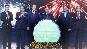 Chủ tịch nước Nguyễn Xuân Phúc và các đại biểu chứng kiến Lễ phát động Tháng công nhân và Tháng hành động về an toàn, vệ sinh lao động năm 2021. Ảnh: TTXVN