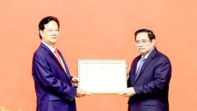 Thủ tướng Phạm Minh Chính trao Huy hiệu 55 năm tuổi Đảng tặng nguyên Thủ tướng Nguyễn Tấn Dũng. Ảnh: TTXVN