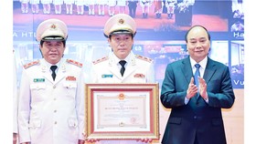 Chủ tịch nước Nguyễn Xuân Phúc trao tặng Huân chương Bảo vệ Tổ quốc hạng nhất cho lực lượng An ninh nhân dân. Ảnh: TTXVN