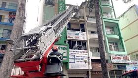 Cảnh sát dùng xe thang cứu 2 nạn nhân tại vụ cháy  trên đường Trần Hưng Đạo (phường 2, quận 5) trưa 11-11