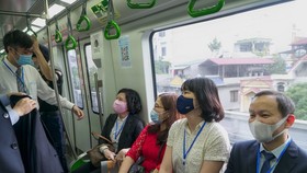 Những hành khách trên chuyến tàu đầu tiên rời ga Cát Linh sau lễ bàn giao dự án metro Cát Linh - Hà Đông - Ảnh: PHẠM TUẤN