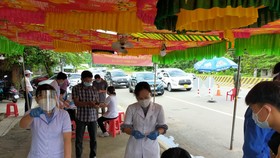 Nhân viên y tế làm việc tại chốt kiểm soát dịch bệnh giáp ranh thị xã Bến Cát và huyện Bàu Bàng, tỉnh Bình Dương
