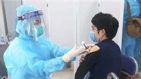 Người dân được nhân viên y tế tiêm vaccine Covid-19 tại một điểm tiêm chủng