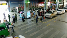 Hành khách đón xe tại cửa ra sân bay Tân Sơn Nhất