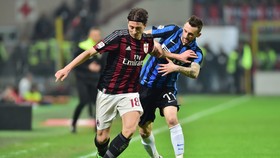 Riccardo Montolivo (trái, AC Milan) đi bóng qua Marcelo Brozovic (Inter Milan). Ảnh: Getty Images.