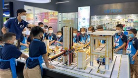 Primary school pupils are studying models displayed in AI Education and Training Center of VNU-HCMC