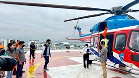 Tourists are in the helicopter tour around HCMC