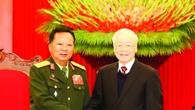 General Secretary of the Communist Party of Vietnam (CPV) Central Committee Nguyen Phu Trong is greeting Deputy Prime Minister and Defence Minister of Laos Chansamone Chanyalath