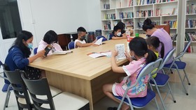 Cư dân và các em nhỏ tại chung cư Belleza (phường Phú Mỹ, quận 7, TPHCM) đọc sách tại CLB Thanh thiếu niên