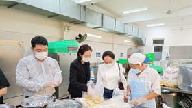 Phụ huynh học sinh Trường Tiểu học Nguyễn Bỉnh Khiêm (quận 1, TPHCM) giám sát chất lượng bữa ăn tại trường vào ngày 1-12