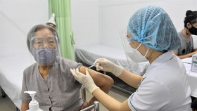 An old people gets vaccinated against Covid-19 at Le Van Thinh Hospital in Thu Duc City.