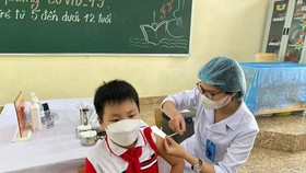 A student of a primary school gets Covid-19 vaccine.
