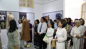 Visitors enjoy exhibits at the exhibition featuring Ao Dai (Vietnamese traditional dress) of Hue ancient imperial city .