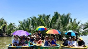 Tourists visit “the seven-acre coconut garden” in Hoi An City's Cam Thanh Commune.