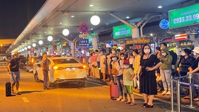Passengers wait for taxis at Tan Son Nhat International Airport.