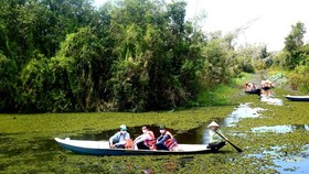 Visitors enjoy a boat tour in Tan Lap Floating Village in Long An Province.