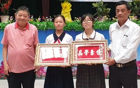杭慰瑤董事長(左一)向學生頒發“品學兼優”金牌。