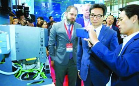 政府副總理武德膽（右二）參觀越南的資訊技術產品。（圖源：越通社）