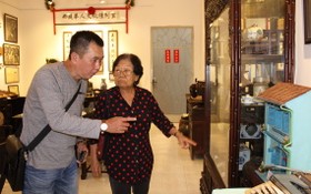 記者在“西堤華人文化陳列室”裡採訪華人革命老前輩李金梅（右）。