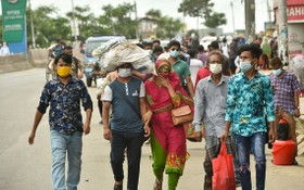 人們走在孟加拉國首都達卡街頭。（圖源：新華社）