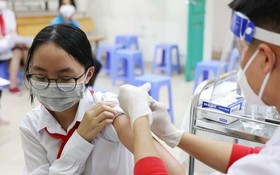 醫護人員為學生接種疫苗。