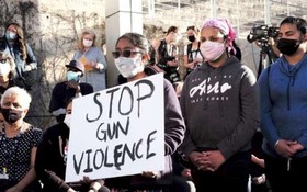 2021年，人們手舉“停止槍枝暴力”的標語在參加槍擊案受害者悼念儀式。圖源：互聯網