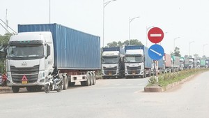 Cargo trucks are waiting for customs clearance procedure at Bac Luan 2 Border Gate