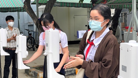 Students of the Saigon Practice High School in District 5 wash their hands before entering the class.