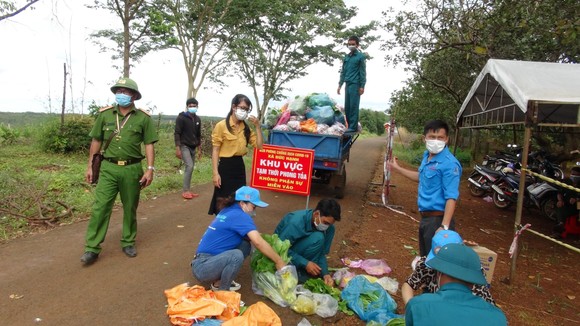 Lực lượng chức năng hỗ trợ đồng bào dân tộc thiểu số ở huyện Bù Gia Mập.