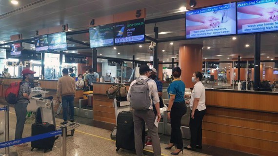 Passengers complete check-in procedures at Yangon Airport.