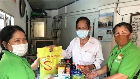 Presenting gifts to poor people (Photo: VNA)
