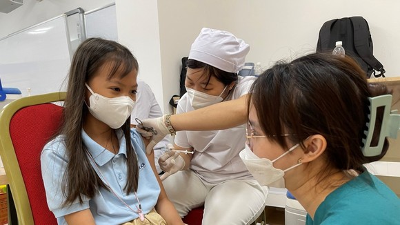 Nhân viên y tế tiêm vaccine cho trẻ