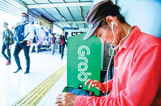 Singapore điều tra Grab thâu tóm Uber ảnh 1