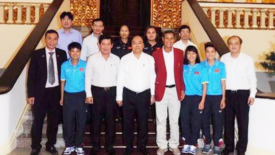 Các thành viên đội tuyển nữ Việt Nam chụp ảnh lưu niệm cùng Thủ tướng Nguyễn Xuân Phúc