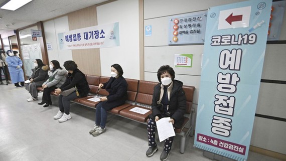 Người dân tuân thủ giãn cách chờ tiêm vaccine COVID-19 tại Seoul. Ảnh: AP