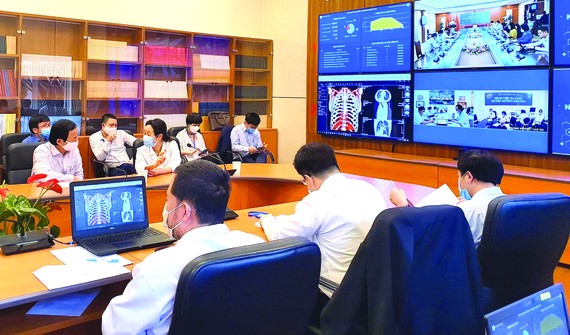 Ứng dụng Telehealth vào điều trị Covid-19 Các bác sĩ Đại học Y Hà Nội đang thăm khám và hội chẩn với bệnh viện tuyến dưới về một ca bệnh. Ảnh: VIẾT CHUNG