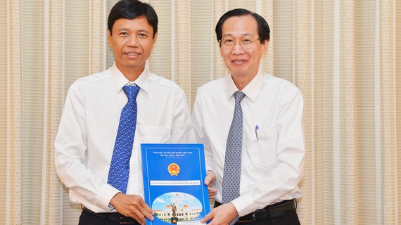 Phó Chủ tịch Thường trực UBNDTPHCM Lê Thanh Liêm trao quyết định cho đồng chí Nguyễn Bá Thành. Ảnh: VIỆT DŨNG 