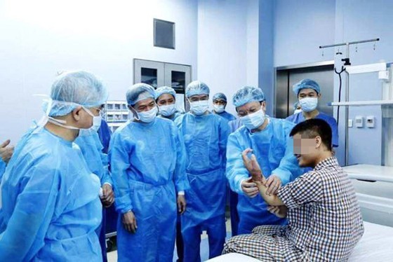Surgeons are examining the man's hand after operation (Photo: SGGP)