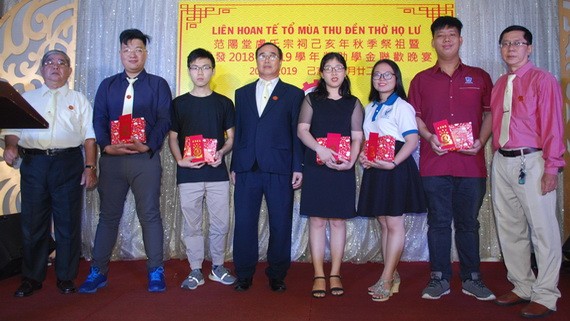 該宗祠理事長盧錦成(左四)與常值理事長盧鏡波(右一)向大學生頒發獎助學金。