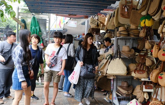 2月22日，韓籍遊客在峴港韓市場選購紀念品。（圖源：晉力）