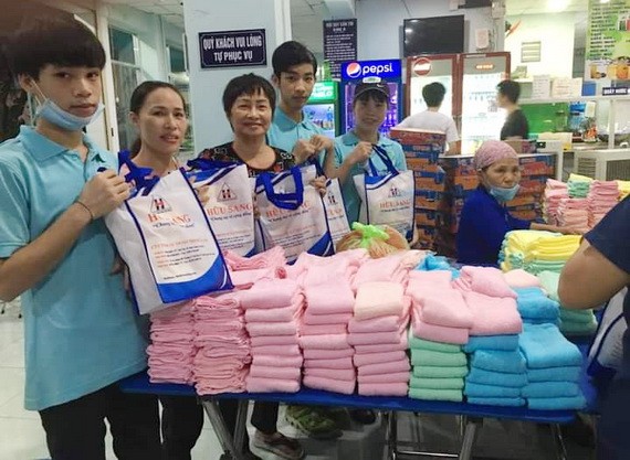 華人商販應氏蓮(左三)與志願者準備慈善禮物。