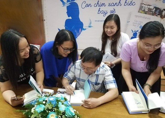 作家阮日映在新書簽名送給讀者。